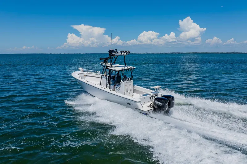 Slide: The Image of 2016 Andros 32 Offshore boat cruising on open water under a clear blue sky. - 14