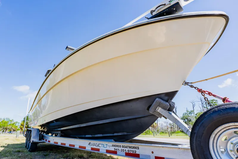 Slide: The Image of 2016 Andros 32 Offshore boat on trailer under clear blue sky. - 93