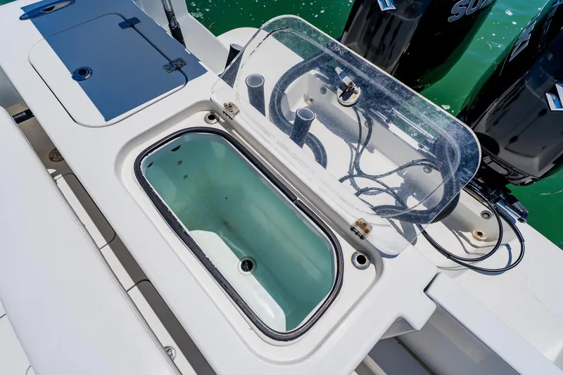 Slide: The Image of Livewell on 2016 Andros 32 Offshore boat with open lid and visible hoses. - 67