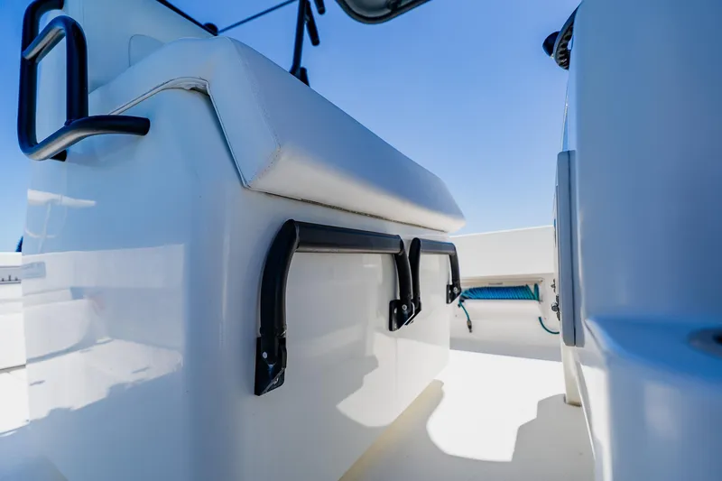 Slide: The Image of 2016 Andros 32 Offshore boat interior with white seating and blue sky background. - 55