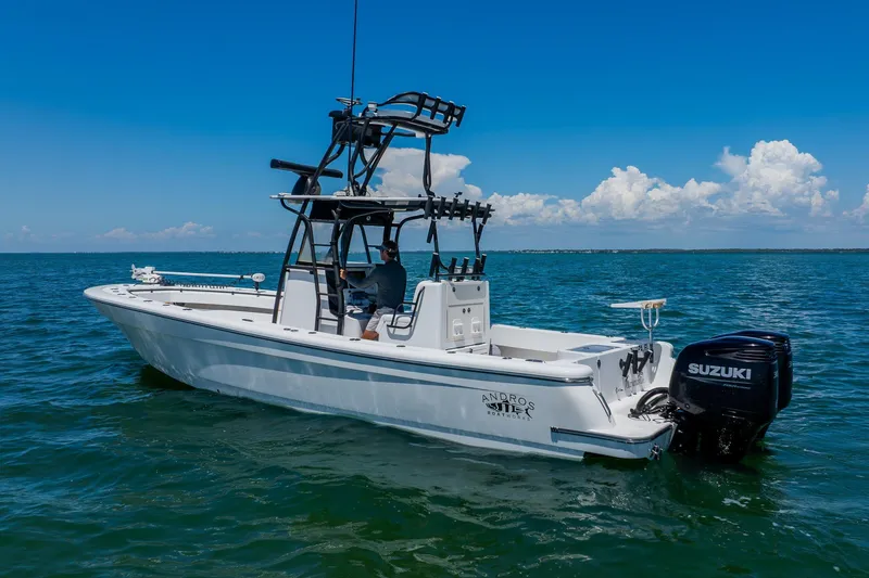 Slide: The Image of 2016 Andros 32 Offshore boat on open water with Suzuki outboard motor. - 7