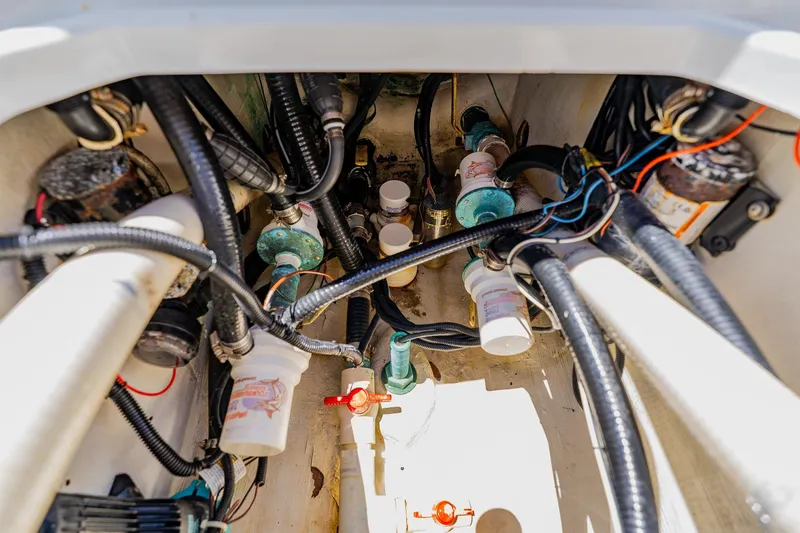 Slide: The Image of Engine compartment of a 2016 Andros 32 Offshore boat, showcasing wiring and plumbing systems. - 77
