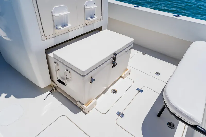 Slide: The Image of 2016 Andros 32 Offshore boat deck with cooler and seating, ocean in background. - 70