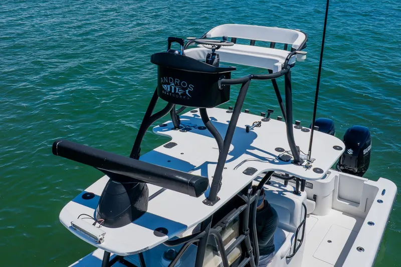 Slide: The Image of 2016 Andros 32 Offshore boat with elevated seating, on clear blue water. - 11