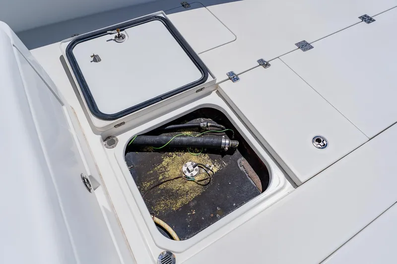 Slide: The Image of Open hatch on 2016 Andros 32 Offshore boat deck, revealing internal components. - 32