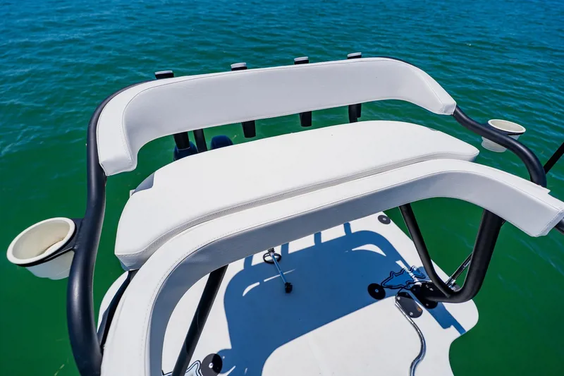 Slide: The Image of 2016 Andros 32 Offshore boat seating with cup holders on calm water. - 88