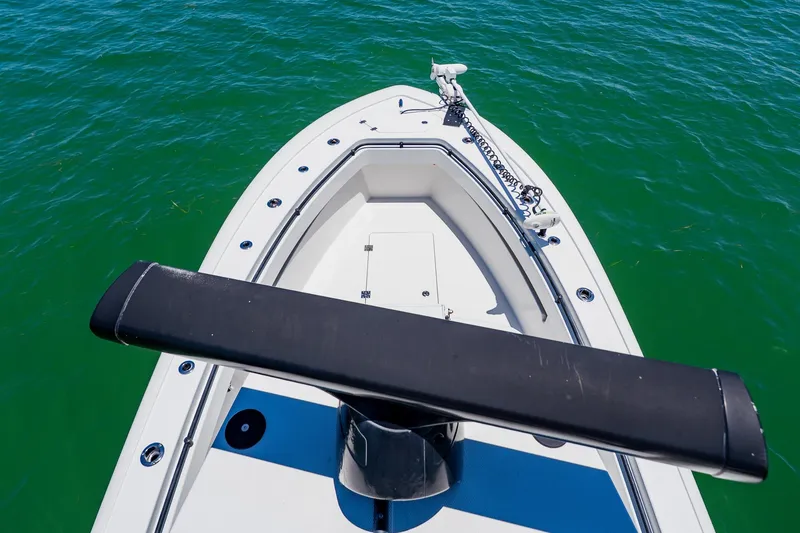Slide: The Image of Bow view of 2016 Andros 32 Offshore boat on clear green water. - 89