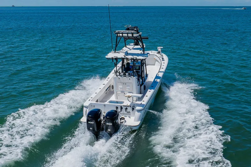 Slide: The Image of 2016 Andros 32 Offshore boat cruising on open water, featuring dual engines. - 13