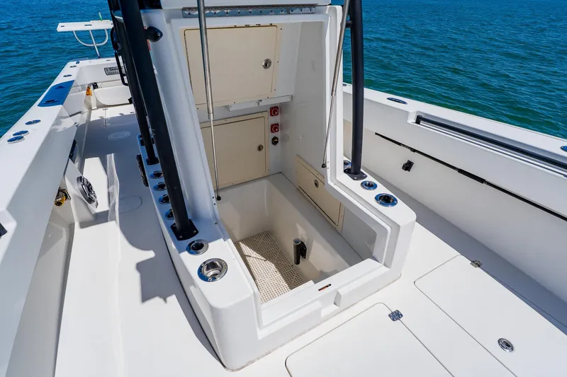 Slide: The Image of 2016 Andros 32 Offshore boat interior with open storage compartment, surrounded by ocean. - 37