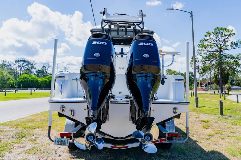 Slide: The Image of 2016 Andros 32 Offshore boat with dual 300 horsepower engines, parked on a sunny day. - 2