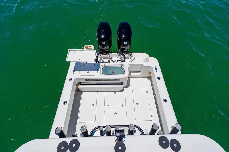 Slide: The Image of 2016 Andros 32 Offshore boat deck with dual engines on green water. - 83