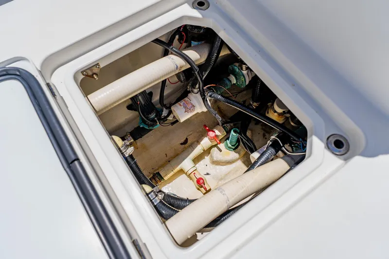Slide: The Image of Open hatch of 2016 Andros 32 Offshore boat showing internal wiring and plumbing. - 76