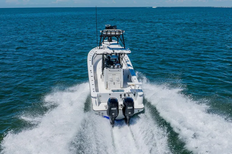 Slide: The Image of 2016 Andros 32 Offshore boat cruising on open water with twin engines. - 16