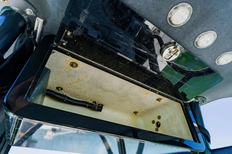 Slide: The Image of Open storage compartment on a 2016 Andros 32 Offshore boat, showing interior details. - 57