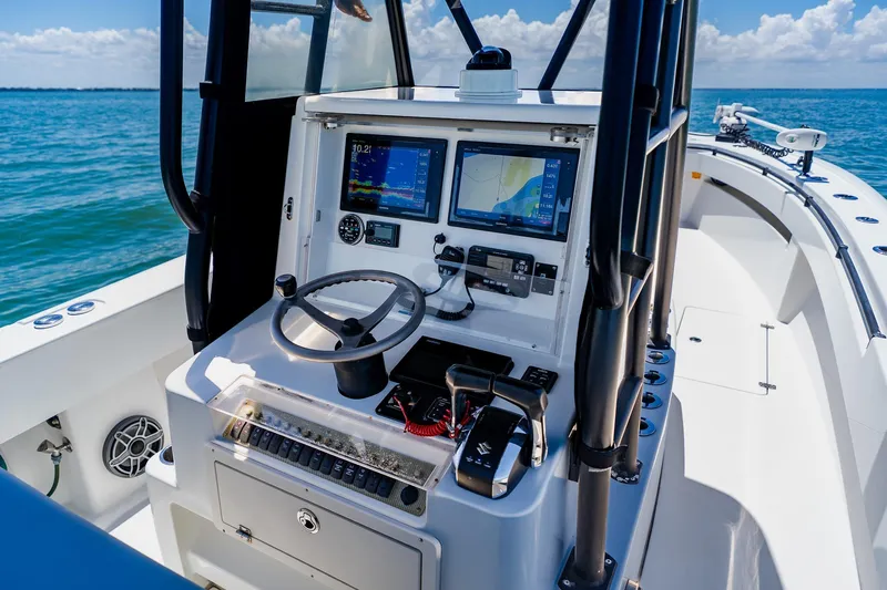 Slide: The Image of 2016 Andros 32 Offshore boat cockpit with navigation screens and steering wheel. - 46
