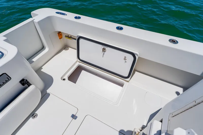 Slide: The Image of 2016 Andros 32 Offshore boat deck with storage compartment, open hatch, and ocean view. - 72