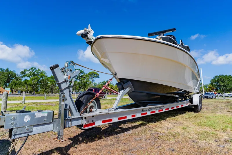 Slide: The Image of 2016 Andros 32 Offshore boat on trailer under clear blue sky. - 92
