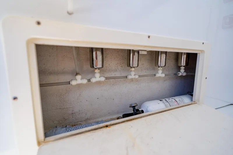 Slide: The Image of Andros 32 Offshore 2016 boat compartment with plumbing and fire extinguisher. - 42