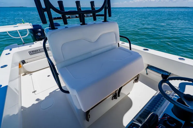 Slide: The Image of 2016 Andros 32 Offshore boat interior with white seating and ocean view. - 54