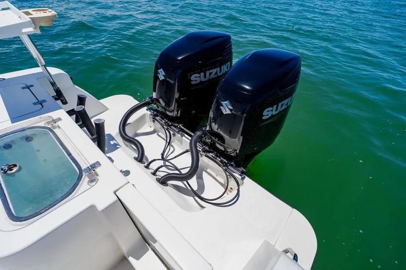 Slide: The Image of Twin Suzuki outboard engines on a 2016 Andros 32 Offshore boat in clear water. - 79