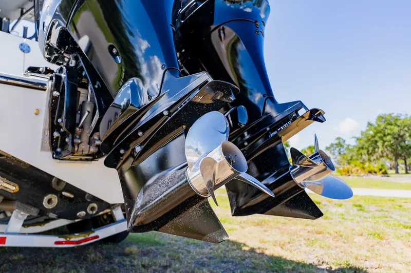 Slide: The Image of Twin outboard motors on a 2016 Andros 32 Offshore boat, showcasing shiny propellers. - 96