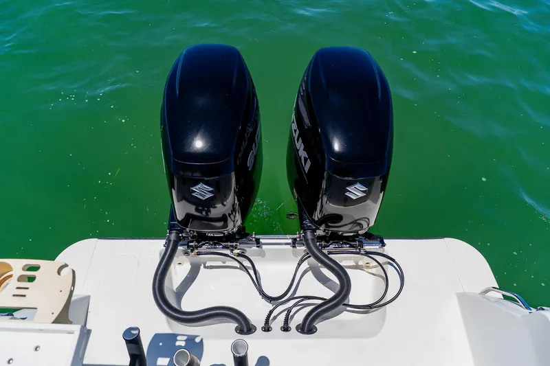 Slide: The Image of Twin Suzuki outboard motors on a 2016 Andros 32 Offshore boat in green water. - 78