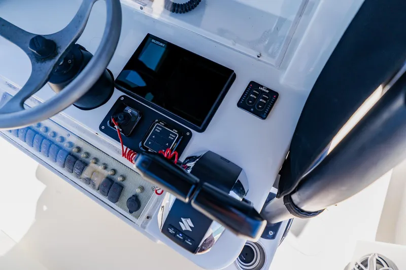 Slide: The Image of 2016 Andros 32 Offshore boat dashboard with steering wheel and control panel. - 49