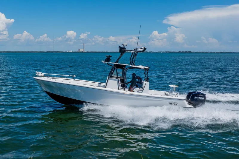 Slide: The Image of 2016 Andros 32 Offshore boat cruising on open water under a clear blue sky. - 15