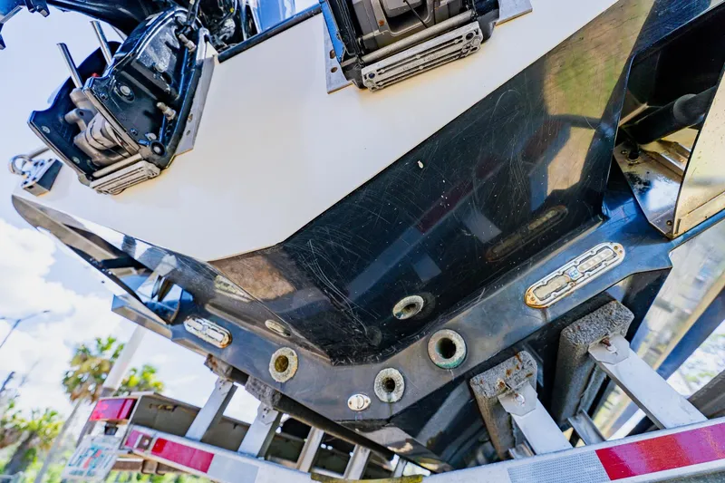 Slide: The Image of 2016 Andros 32 Offshore boat hull and engine detail on trailer. - 95