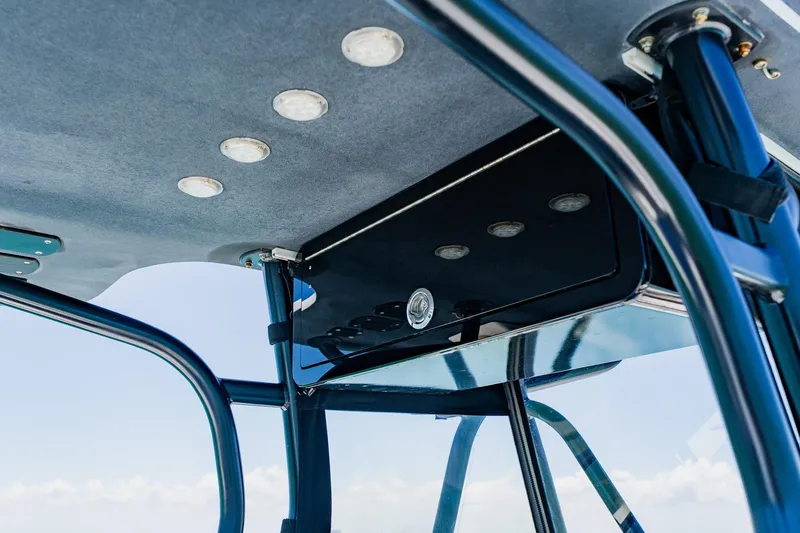 Slide: The Image of 2016 Andros 32 Offshore boat's T-top with integrated lighting and sturdy frame. - 58