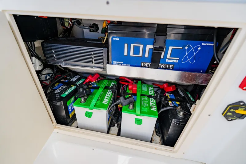Slide: The Image of Battery compartment of a 2016 Andros 32 Offshore boat, featuring multiple marine batteries. - 40
