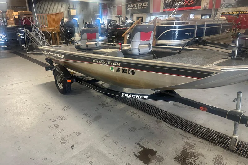 Slide: The Image of 2015 Tracker Panfish 16 boat on trailer in showroom, featuring dual seats. - 5