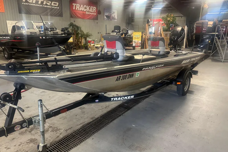 Slide: The Image of 2015 Tracker Panfish 16 boat in showroom, featuring dual seats and Minn Kota trolling motor. - 3