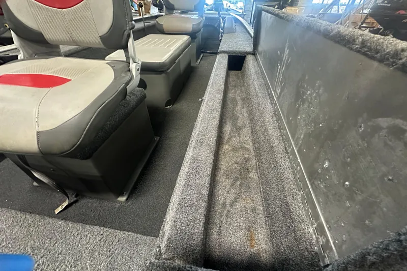 Slide: The Image of Interior of 2015 Tracker Panfish 16 boat showing seating and storage area. - 12
