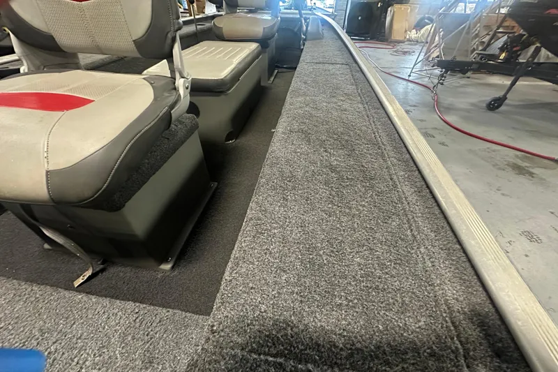 Slide: The Image of Interior view of a 2015 Tracker Panfish 16 boat with cushioned seating. - 13