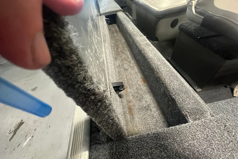 Slide: The Image of 2015 Tracker Panfish 16 boat interior with carpeted storage compartment. - 14