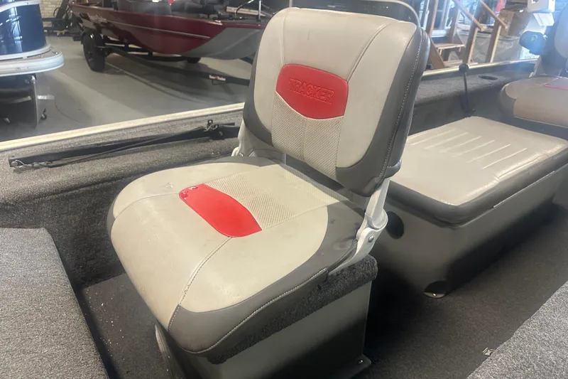 Slide: The Image of 2015 Tracker Panfish 16 boat interior with gray and red seating. - 9