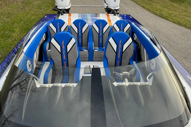 Slide: The Image of 2023 Skater 318 boat interior with blue and gray seats, sleek design. - 4