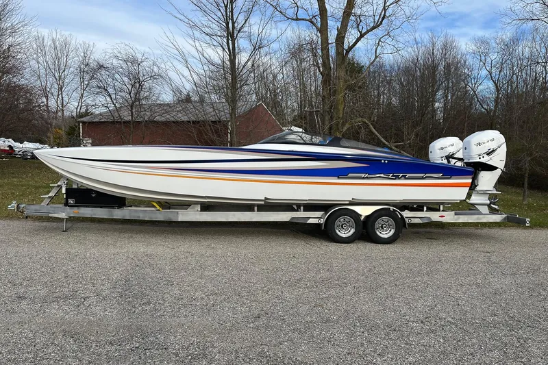 The Image of 2023 Skater 318 powerboat on trailer, featuring sleek design and dual engines. - 1