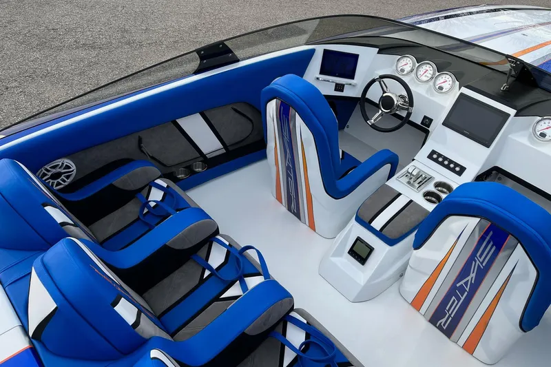 Slide: The Image of Interior of 2023 Skater 318 boat with blue and white seating, modern dashboard, and steering wheel. - 7