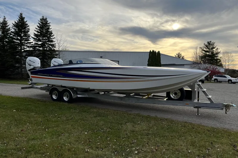 Slide: The Image of 2023 Skater 318 boat on trailer, parked outdoors under a cloudy sky. - 11