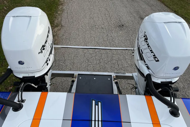 Slide: The Image of Twin Mercury Racing 400 outboard engines on a 2023 Skater 318 boat, featuring vibrant blue and orange accents. - 8