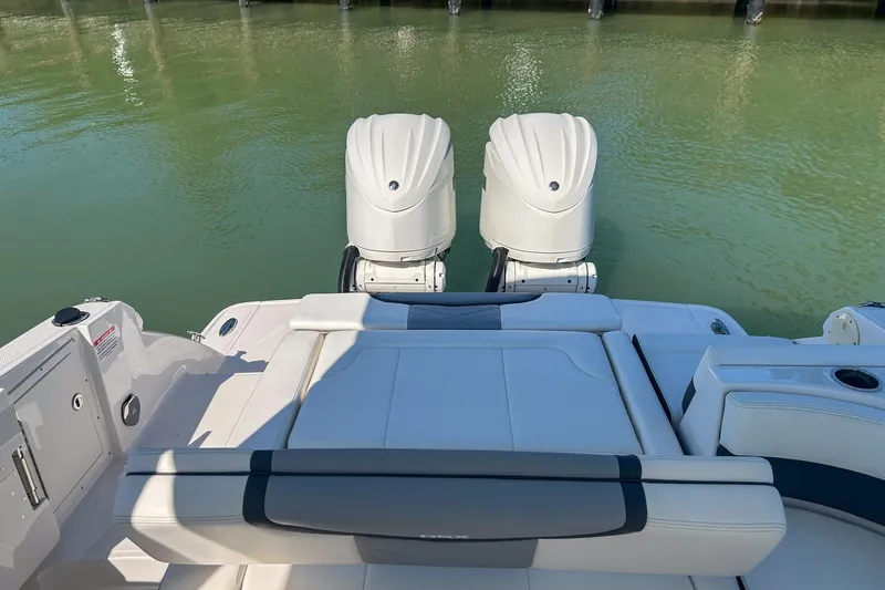 Slide: The Image of 2024 Chaparral 280 OSX boat with dual engines on calm water. - 12