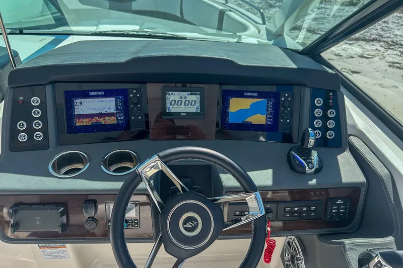 Slide: The Image of 2024 Chaparral 280 OSX dashboard with Simrad displays and steering wheel. - 14