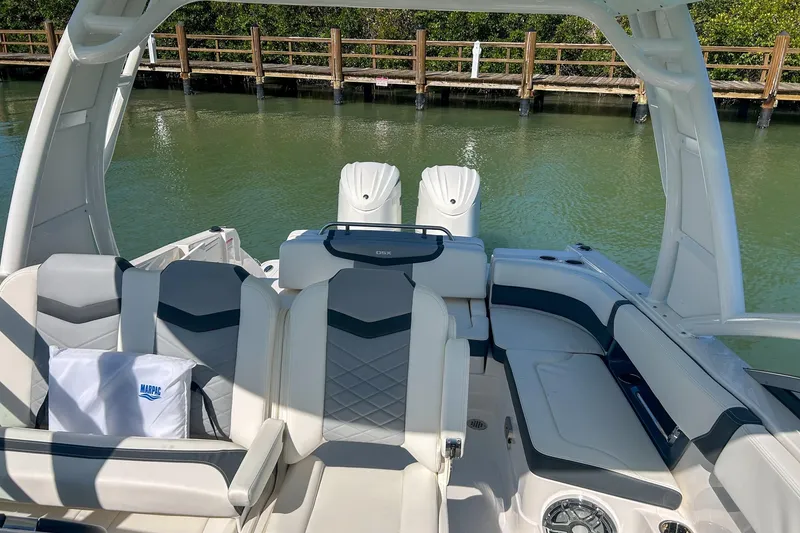 Slide: The Image of 2024 Chaparral 280 OSX boat interior with luxurious seating and dual engines. - 7