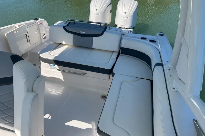 Slide: The Image of 2024 Chaparral 280 OSX boat interior with luxurious seating and dual outboard motors. - 9