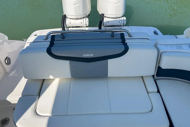 Slide: The Image of 2024 Chaparral 280 OSX boat seating with dual outboard motors on water. - 10