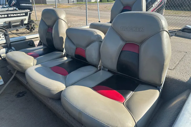 Slide: The Image of 1999 Tracker Pro Team 185 boat seats with gray, black, and red upholstery. - 13