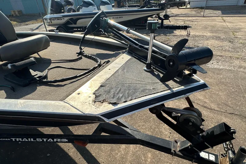 Slide: The Image of 1999 Tracker Pro Team 185 boat with trolling motor on trailer in outdoor setting. - 22
