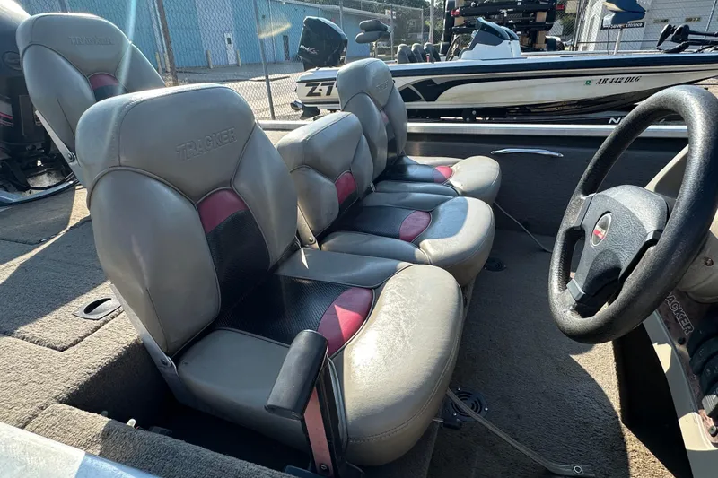 Slide: The Image of 1999 Tracker Pro Team 185 boat interior with gray and red seating. - 23
